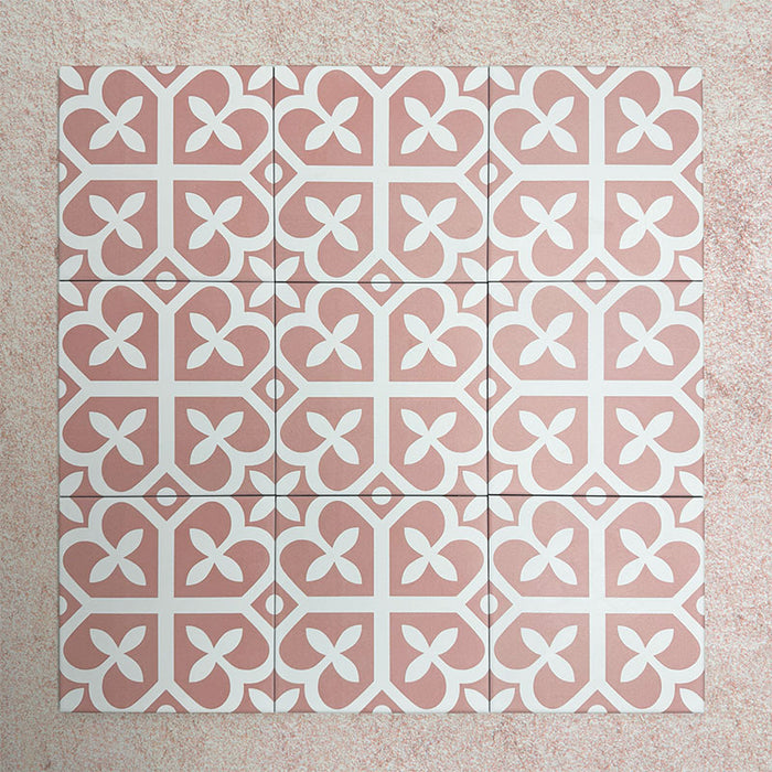 Iris Pink Victorian Moroccan-style 20x20cm patterned porcelain tiles arranged in a tiled group, showcasing a soft pink and white geometric design.