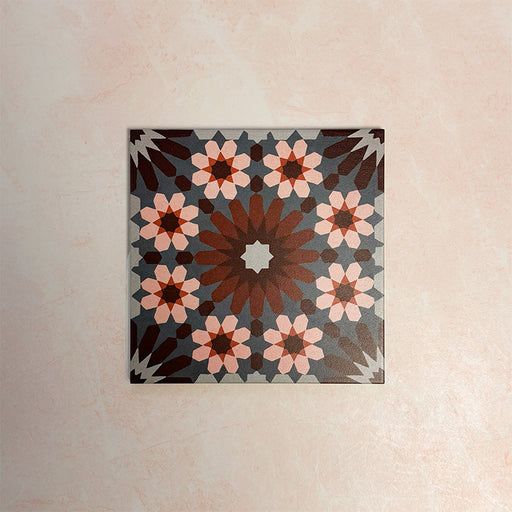Single Fizaan Rosso 20x20cm Moroccan-style porcelain tile featuring a bold geometric pattern in warm red, soft blue and neutral tones.