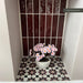 Recessed wall niche featuring Mamounia Vino 20 × 20cm Moroccan-style wall and floor tiles with a bold geometric pattern, paired with deep red gloss brick tiles and styled with a potted floral arrangement.