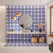 Bathroom featuring Santillana Blue and Yellow patterned wall and floor tiles, showcasing a bold Mediterranean-inspired floral geometric design in vibrant cobalt blue, warm yellow and crisp white tones, paired with a floating stone vanity, round mirror, woven pendant lights, natural baskets and soft neutral finishes for a bright, characterful interior.