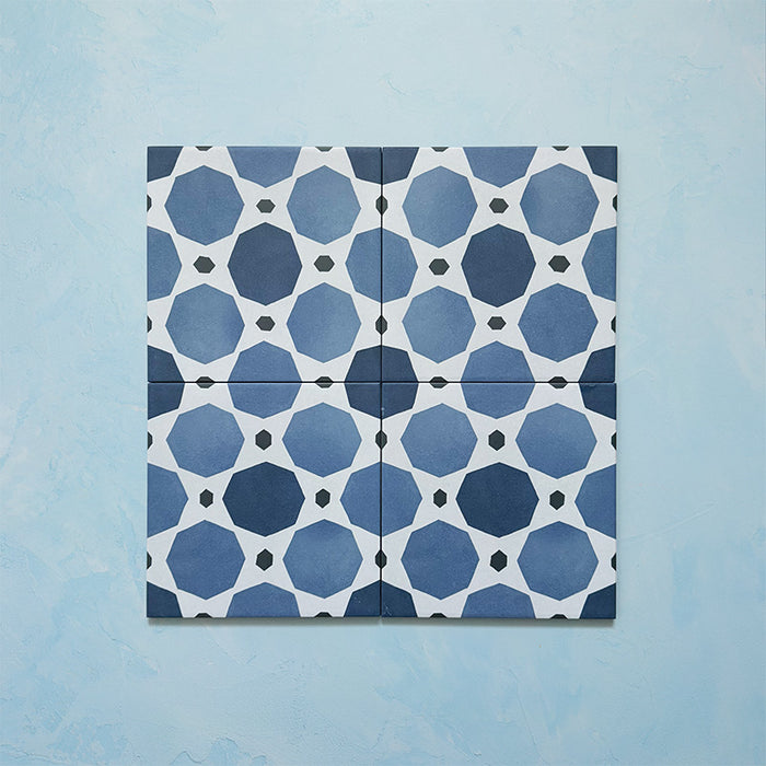 Four-tile layout of Carnaby Sapphire Victorian-style 20x20cm porcelain wall and floor tiles, highlighting the repeating blue geometric octagon pattern with white connecting lines and small charcoal accents.