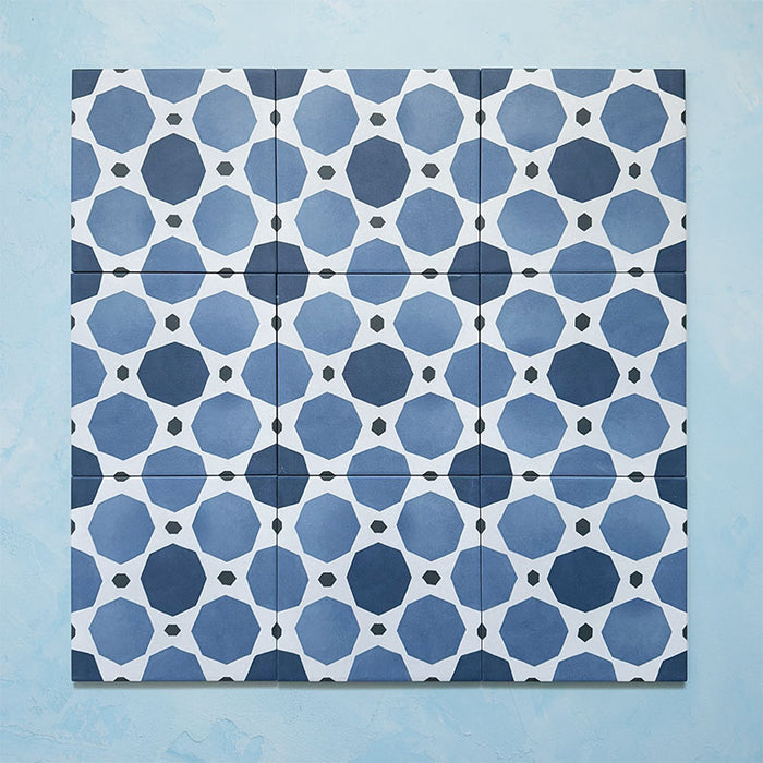 Grouped layout of Carnaby Sapphire Victorian-style 20x20cm porcelain wall and floor tiles, showing the full repeating blue geometric octagon pattern with white connecting lines and small charcoal accents.