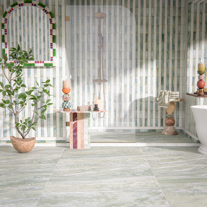 Bathroom setting featuring Paradis Marble Verde 60x120cm marble effect floor tiles, showcasing soft green tones with natural veining, paired with vertically laid brick wall tiles and organic styling for a calm, spa-inspired finish.