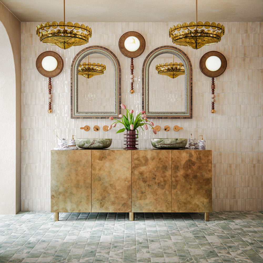Bathroom featuring Atlas Canvas Mini Brick 5x15cm gloss wall tiles, installed in a vertical layout, showcasing soft neutral tones, paired with statement mirrors, brass fittings, and a warm, design-led interior setting.