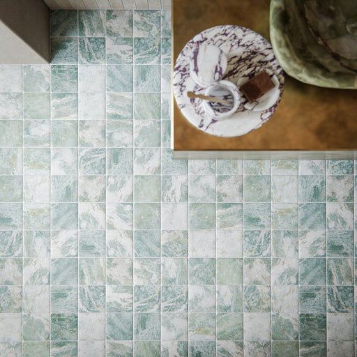 Bathroom featuring Giovanni Square Salvia Vintage Marble 11x11cm wall and floor tiles, showcasing soft green and white marble effect tones, laid in a classic grid pattern, paired with warm brass fittings and a refined, design-led interior.