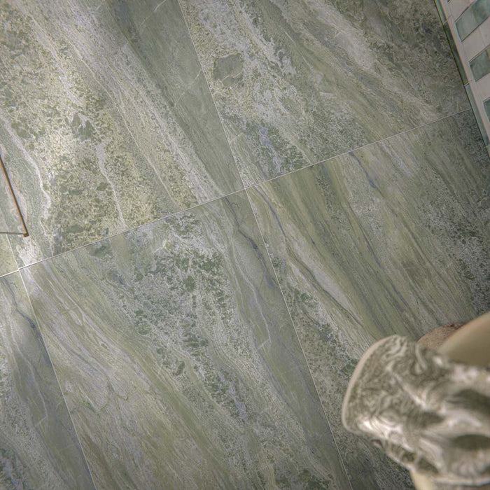 Bathroom setting featuring Paradis Marble Verde 60x120cm marble effect floor tiles, showcasing soft green tones with natural veining, paired with vertically laid brick wall tiles and organic styling for a calm, spa-inspired finish.