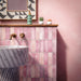 Bathroom setting featuring Fusion Bricks Coral Pink 6.5x20cm brick wall tiles, showcasing soft tonal variation, paired with a fluted marble basin, brass fittings and warm pink walls for a refined, design-led finish.