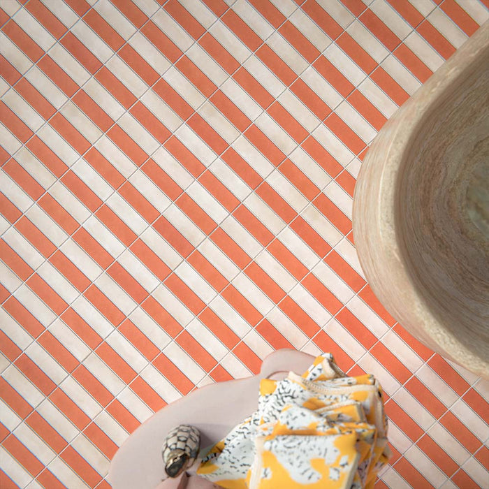 Bathroom setting featuring Atlas Canvas and Atlas Cotto Mini Brick 5x15cm matt wall and floor tiles, laid in a striped layout, showcasing warm neutral and terracotta tones, paired with a freestanding stone bath and brass fittings.