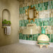Bathroom interior featuring Veneto Medium Sand 60x60cm terrazzo effect porcelain floor tiles, paired with green brick wall tiles, brass fixtures and a sculptural basin for a warm, design-led finish.