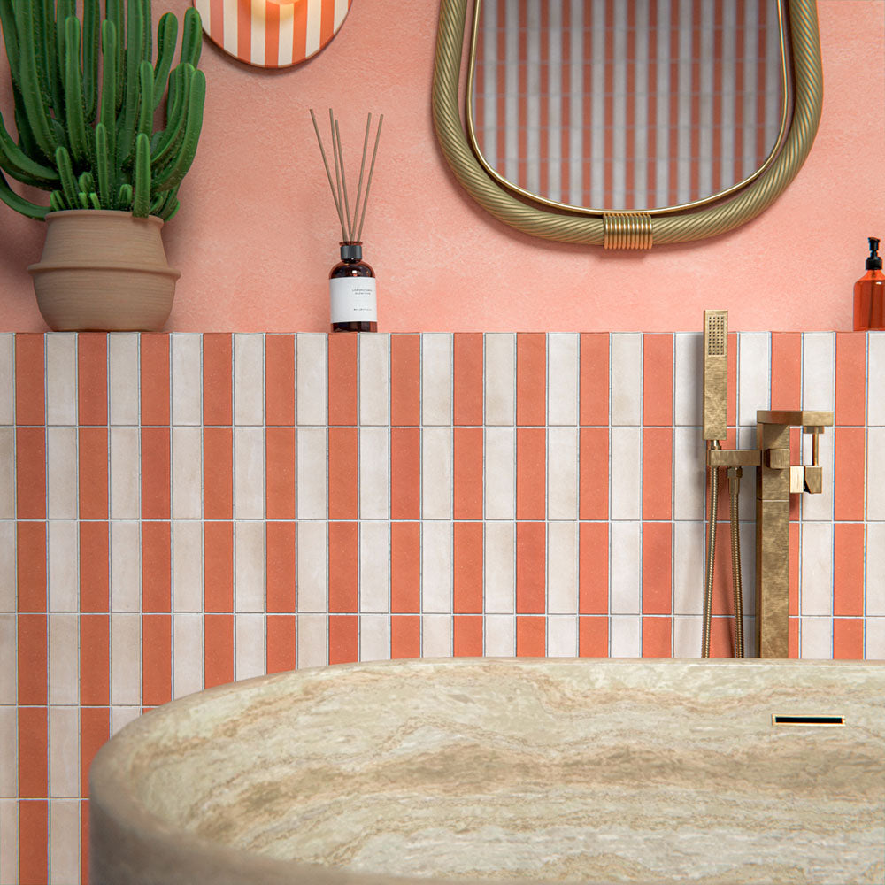 Bathroom setting featuring Atlas Canvas and Atlas Cotto Mini Brick 5x15cm matt wall and floor tiles, laid in a striped layout, showcasing warm neutral and terracotta tones, paired with a freestanding stone bath and brass fittings.