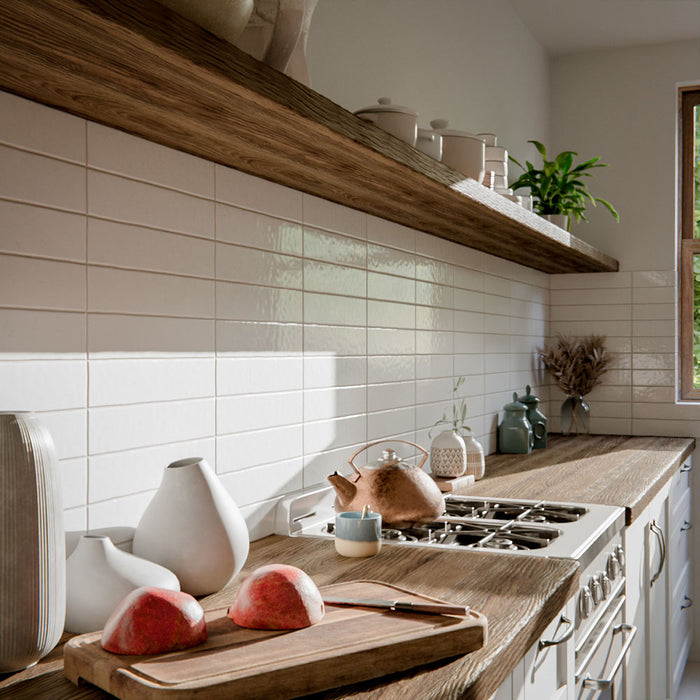 Kitchen featuring Malaga White Sand Brick gloss ceramic wall tiles in a 6.5 × 32.8cm format, used as a splashback alongside wooden worktops and open shelving for a warm, modern look.