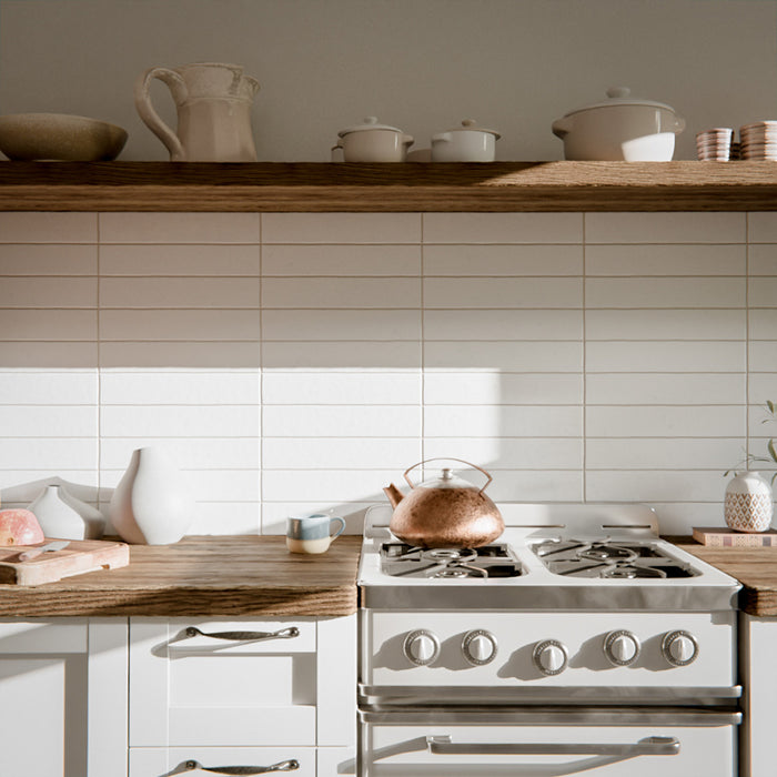 Kitchen featuring Malaga White Sand Brick gloss ceramic wall tiles in a 6.5 × 32.8cm format, used as a splashback alongside wooden worktops and open shelving for a warm, modern look.