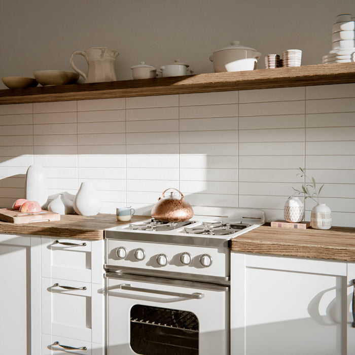 Kitchen featuring Malaga White Sand Brick gloss ceramic wall tiles in a 6.5 × 32.8cm format, used as a splashback alongside wooden worktops and open shelving for a warm, modern look.
