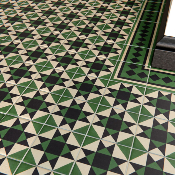  Close-up of Maison Green Decor Victorian patterned 20x20cm ceramic floor tiles in green, black and white geometric design.