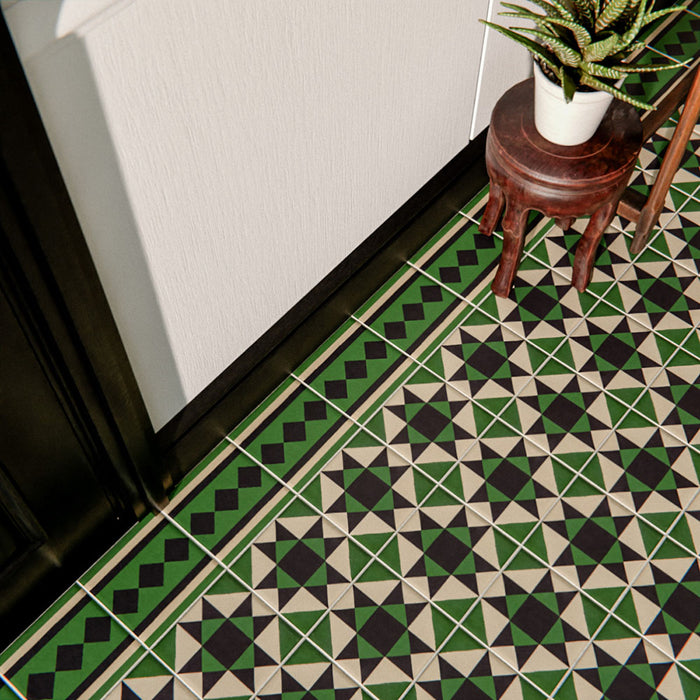 Close-up of Maison Green Decor Victorian patterned 20x20cm ceramic floor tiles in green, black and white geometric design.