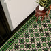 Close-up of Maison Green Decor Victorian patterned 20x20cm ceramic floor tiles in green, black and white geometric design.