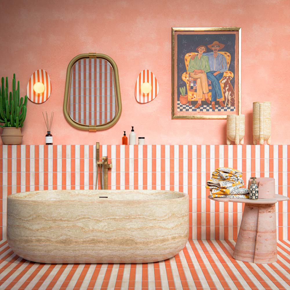 Bathroom setting featuring Atlas Canvas and Atlas Cotto Mini Brick 5x15cm matt wall and floor tiles, laid in a striped layout, showcasing warm neutral and terracotta tones, paired with a freestanding stone bath and brass fittings.