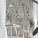 Interior corner featuring Sensei Flowers Decor 60 × 120cm porcelain wall tiles, styled with a small dining table, wooden chair, indoor plants, and soft natural light for a calm, nature-inspired setting.
