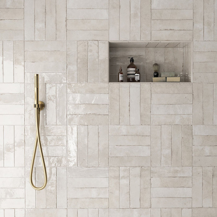 Madison Oatmeal Brick Wall Tiles 6x24.6cm — shown in a serene shower setting. These warm neutral tiles blend soft beige and cream tones with a handcrafted texture and glossy finish, creating a spa-like atmosphere that feels both timeless and contemporary.
