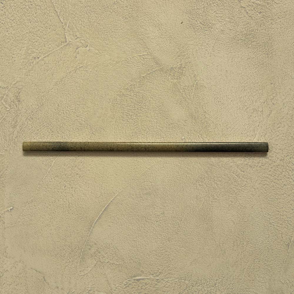 Izmir Daisy Green Gloss Pencil Bullnose Border Tile 1.2x30cm displayed on a textured beige background, showing its slim rounded edge and smooth glossy finish.