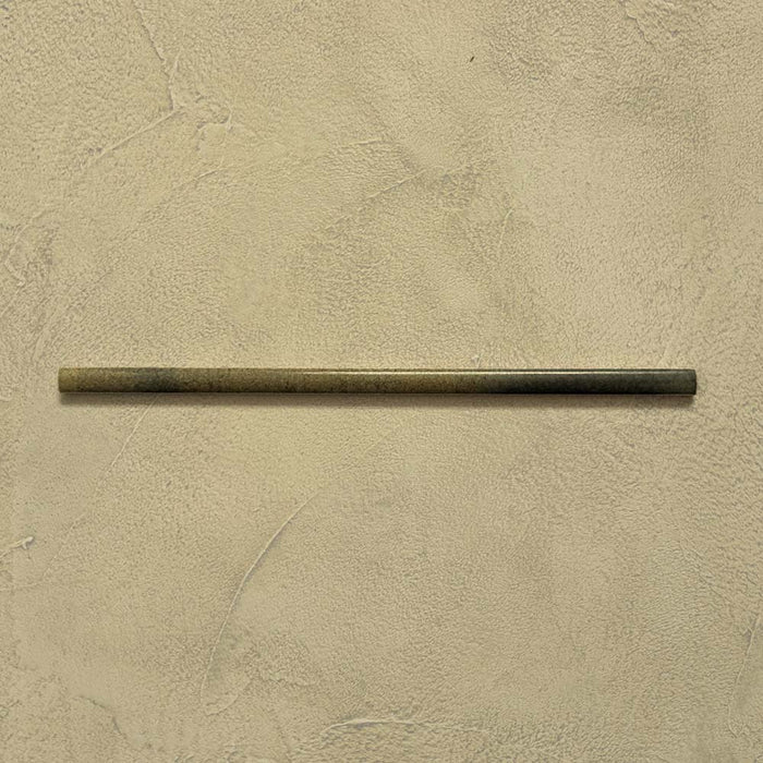 Izmir Daisy Green Gloss Pencil Bullnose Border Tile 1.2x30cm displayed on a textured beige background, showing its slim rounded edge and smooth glossy finish.