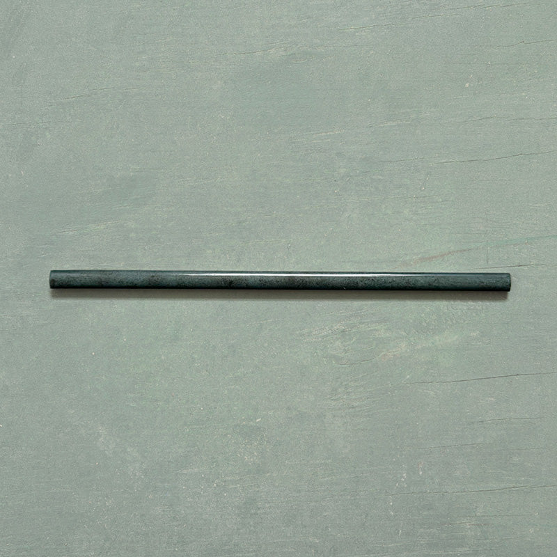 Izmir Green Gloss Pencil Bullnose Border Tile 1.2x30cm displayed on a soft green background, showing its slim curved edge and glossy handcrafted effect finish.