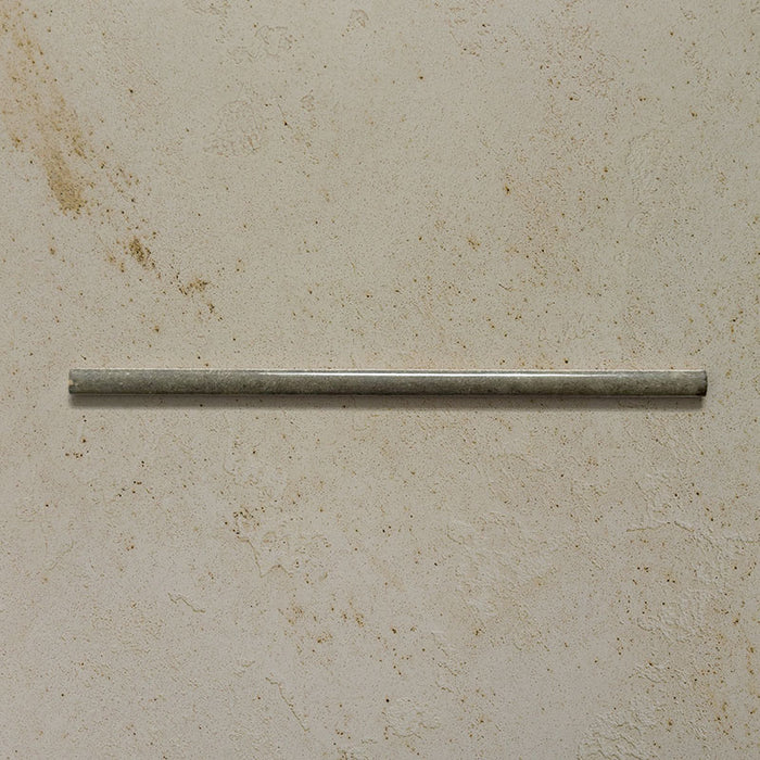 Izmir Sage Green Gloss Pencil Bullnose Border Tile 1.2x30cm displayed on a textured beige background, showing its slim rounded edge and glossy handcrafted effect finish.