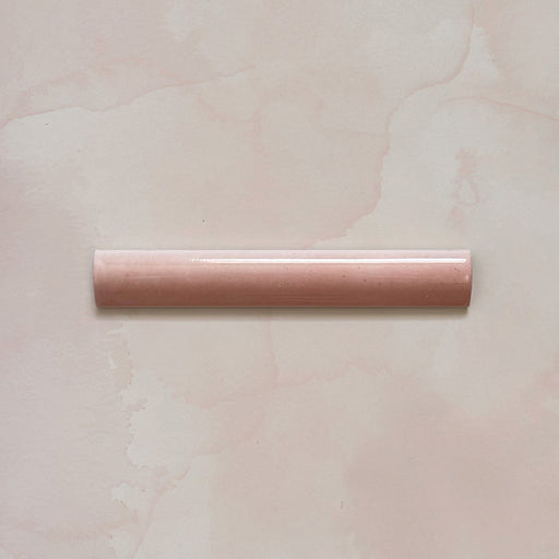 Madison Rose Bullnose Pencil Border Tile 3x20cm — single piece shown. Designed to complement the Madison Rose brick tiles, this soft blush bullnose trim features a smooth curved profile and glossy glaze, ideal for framing edges and adding a refined finishing touch.