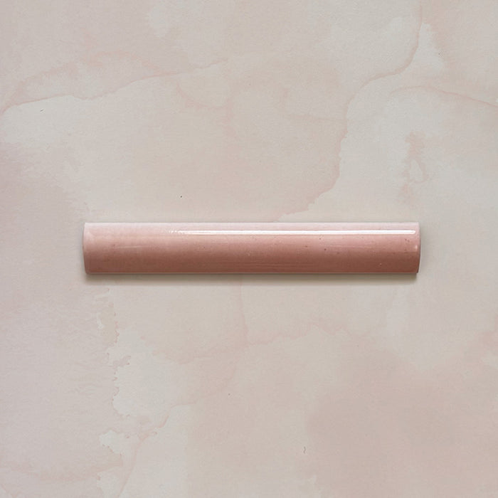 Madison Rose Bullnose Pencil Border Tile 3x20cm — single piece shown. Designed to complement the Madison Rose brick tiles, this soft blush bullnose trim features a smooth curved profile and glossy glaze, ideal for framing edges and adding a refined finishing touch.