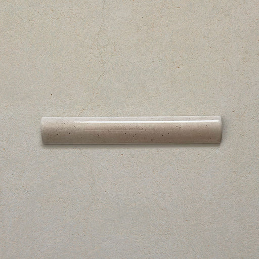 Madison Oatmeal Bullnose Pencil Border Tile 3x20cm — single piece shown. Its smooth rounded profile and soft oatmeal glaze offer a beautiful finishing touch for tiled walls, ideal for framing edges, recesses, or creating a seamless transition between surfaces.