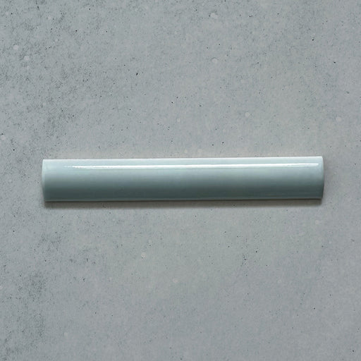 Zellij Aqua Blue Bullnose Moroccan Style 3cm x 20cm glazed ceramic trim tile in soft aqua blue tones, smooth rounded bullnose edge, glossy finish, handcrafted zellige look with subtle tonal variation, ideal for edging walls, niches, and decorative tile layouts.