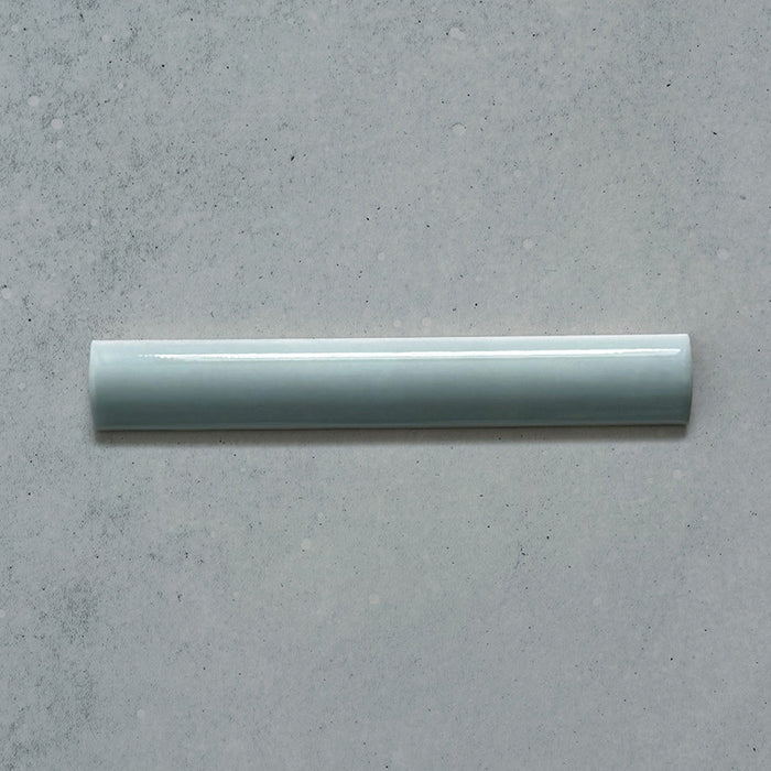 Zellij Aqua Blue Bullnose Moroccan Style 3cm x 20cm glazed ceramic trim tile in soft aqua blue tones, smooth rounded bullnose edge, glossy finish, handcrafted zellige look with subtle tonal variation, ideal for edging walls, niches, and decorative tile layouts.