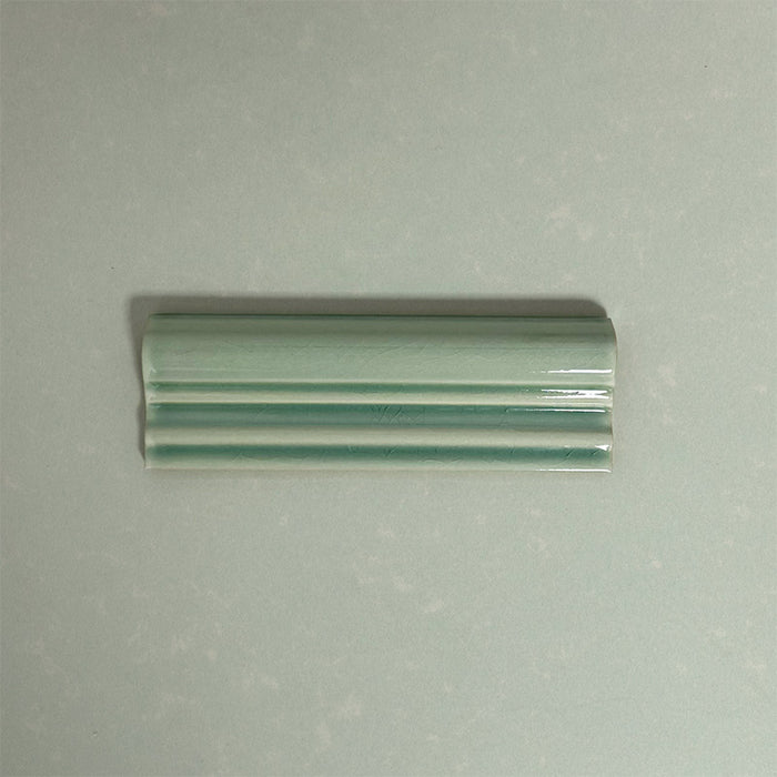 Finchley Lime Green ceramic dado trim tile in a 5 × 15cm format, featuring a crackle glaze finish that adds subtle texture and a decorative, classic detail to wall tile designs.