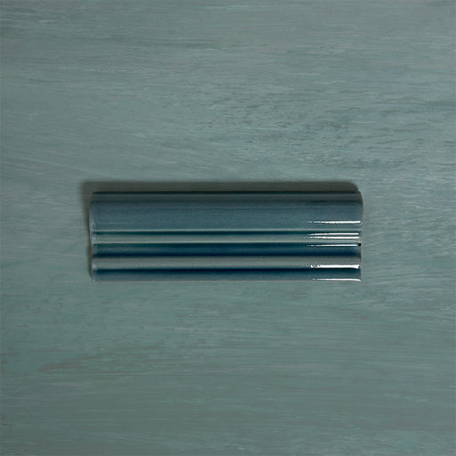 Finchley River Blue ceramic dado trim tile in a 5 × 15cm format, featuring a crackle glaze finish that adds depth, texture and a decorative, classic detail to wall tile designs.