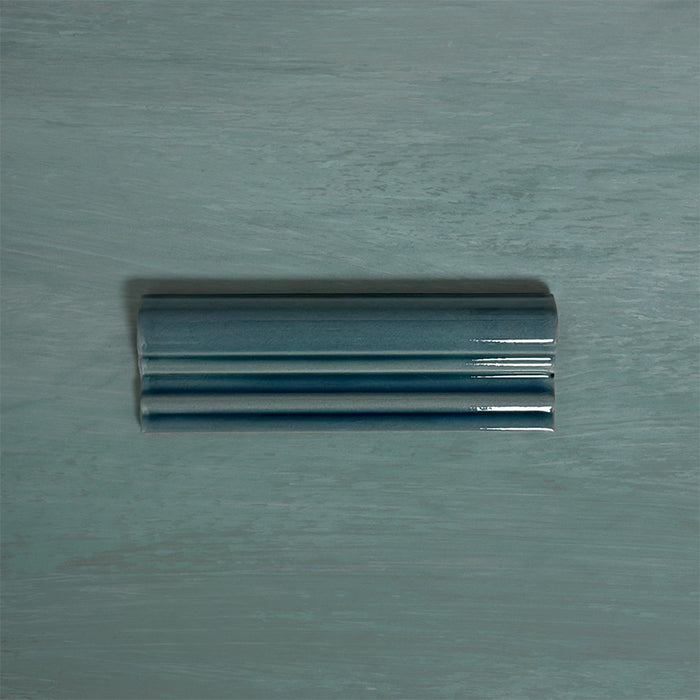Finchley River Blue ceramic dado trim tile in a 5 × 15cm format, featuring a crackle glaze finish that adds depth, texture and a decorative, classic detail to wall tile designs.