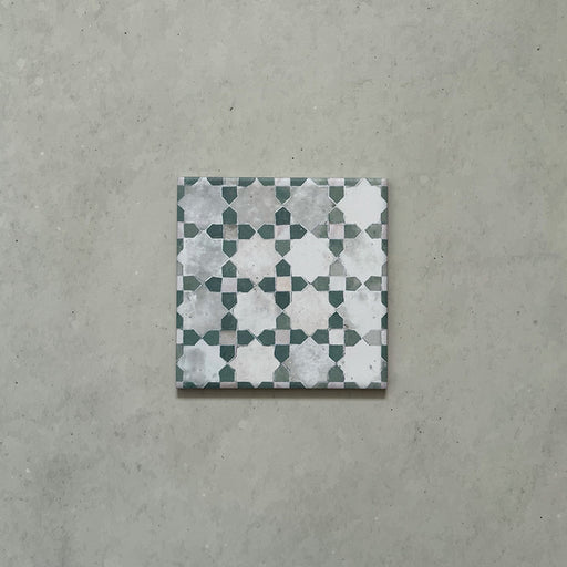 Single Bedouin Mequinez Green Moroccan-style 15x15cm tile featuring a traditional geometric star and cross pattern in green, white, and soft grey tones with a weathered, handmade effect.