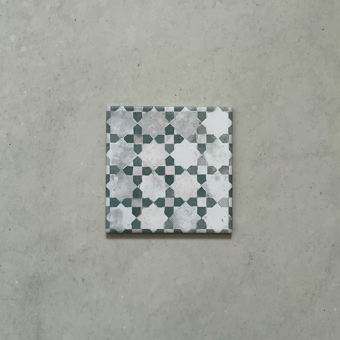 Single Bedouin Mequinez Green Moroccan-style 15x15cm tile featuring a traditional geometric star and cross pattern in green, white, and soft grey tones with a weathered, handmade effect.