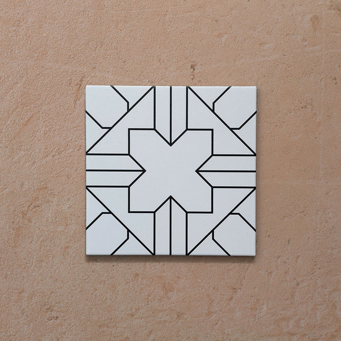 Alhambra Palacio 20x20cm Moroccan tile single tile shot, featuring a clean white background with an intricate black geometric cross pattern for a bold yet timeless design.