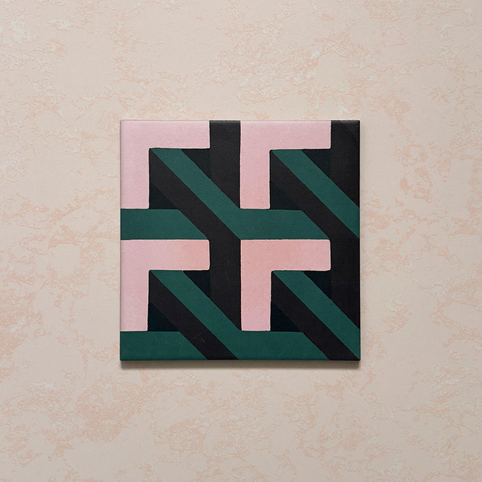Single Geometry Lagoon 20x20cm patterned ceramic tile featuring an interlocking geometric design in blush pink, deep teal, and charcoal tones, displayed against a soft textured beige backdrop.