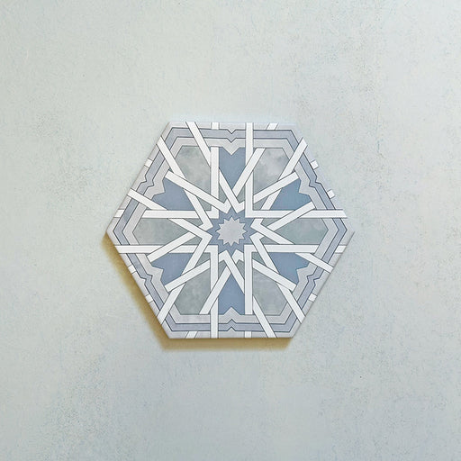 Maroush Mareshan Azure Blue 18.7x21.6cm Moroccan hexagonal tile featuring an intricate white starburst pattern on a soft blue background, inspired by traditional Moroccan craftsmanship.