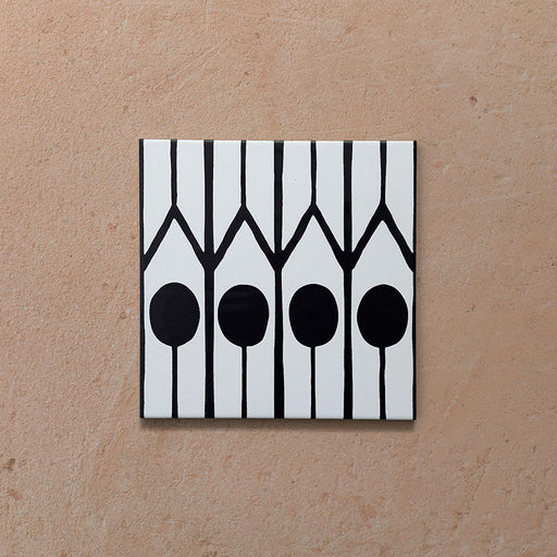 Alhambra Felisa 20x20cm Moroccan single tile featuring a bold black and white geometric pattern with vertical lines and circular shapes inspired by traditional Moroccan design.