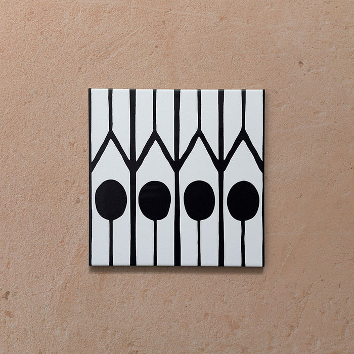 Alhambra Felisa 20x20cm Moroccan single tile featuring a bold black and white geometric pattern with vertical lines and circular shapes inspired by traditional Moroccan design.