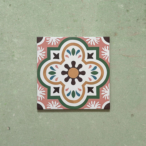 Cabana Paradise 20x20cm Moroccan-style ceramic tile shown as a single piece, featuring a multicolour floral pattern with pink, green, and mustard tones on a soft green background.