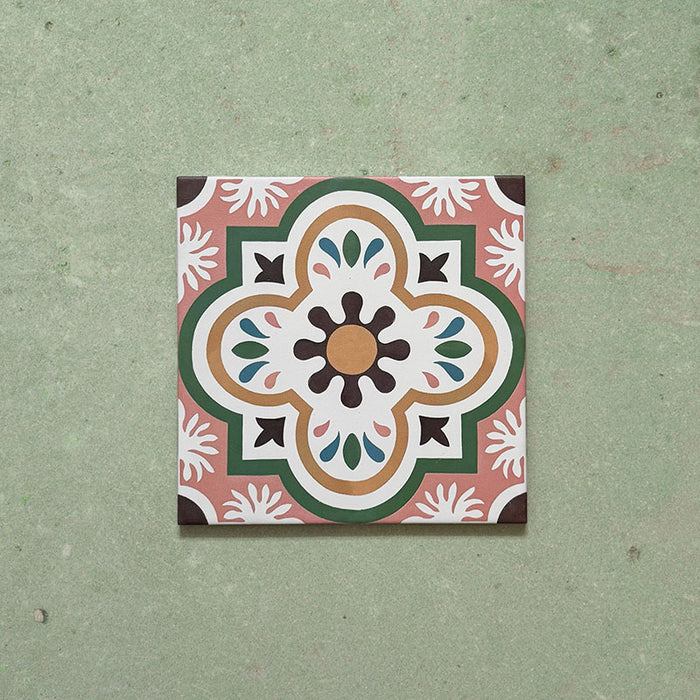 Cabana Paradise 20x20cm Moroccan-style ceramic tile shown as a single piece, featuring a multicolour floral pattern with pink, green, and mustard tones on a soft green background.