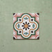 Cabana Paradise 20x20cm Moroccan-style ceramic tile shown as a single piece, featuring a multicolour floral pattern with pink, green, and mustard tones on a soft green background.