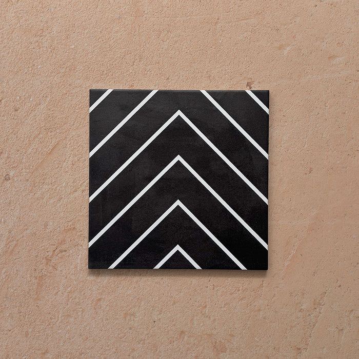 Alhambra Zig Zag Black 20x20cm Moroccan tile featuring a bold chevron design in black with crisp white lines, creating a modern geometric pattern perfect for contemporary interiors.