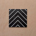 Alhambra Zig Zag Black 20x20cm Moroccan tile featuring a bold chevron design in black with crisp white lines, creating a modern geometric pattern perfect for contemporary interiors.