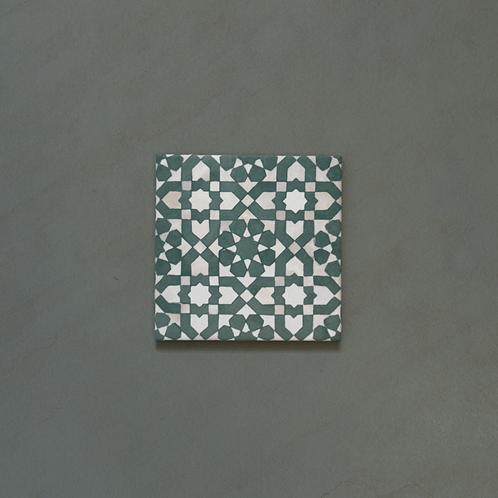 Bedouin Tetuan Green Moroccan-style 15x15cm single tile featuring an intricate star and cross pattern in deep green, soft beige, and white tones, with a subtle handmade effect and matte finish.
