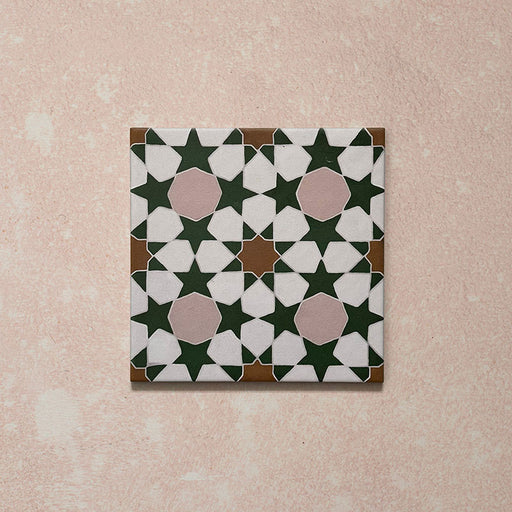 Cabana Tanane Moroccan Style 20x20cm single porcelain tile featuring a geometric star and cross pattern in deep green, soft pink, white, and tan tones with a smooth matt finish.