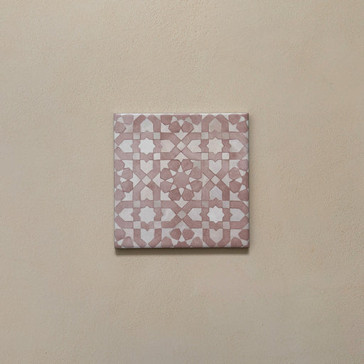 Bedouin Tetuan Rose Moroccan-style 15x15cm single tile featuring an intricate geometric pattern in blush pink and soft white tones, displayed on a warm neutral background to highlight its handcrafted matte finish and subtle texture.